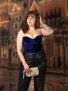 model wearing a special event purple velvet bustier corset top with leather pants in holiday street scene