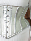 detail view of a silver metallic faux leather mesh waist training corset with steel bones