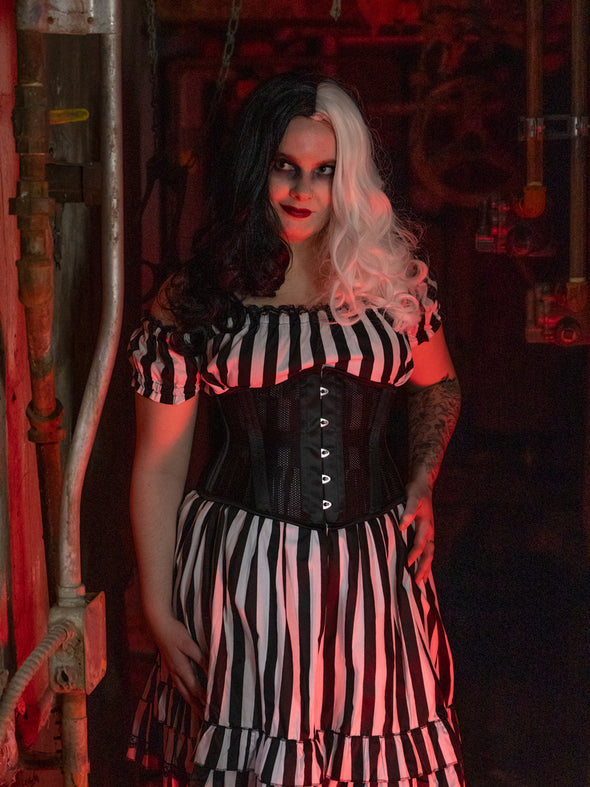 Cute model wearing a black and white wig beetlejuice costume with black mesh waist training corset 