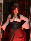 Cute model dressed in medieval steampunk costume with black mesh waist training corset