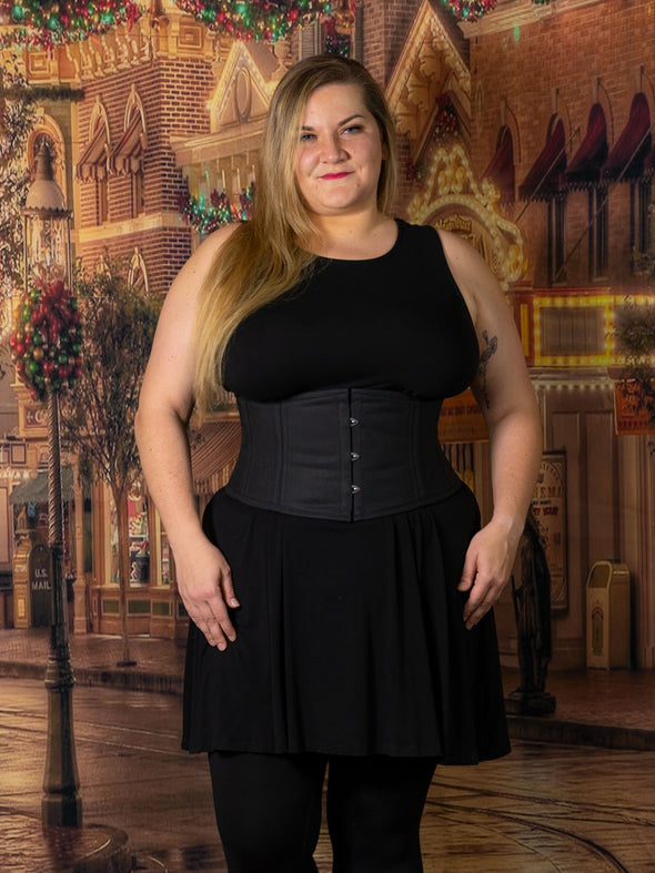 cute curvy plus size corset model wearing a cs301 waist training corset with a black dress and stockings