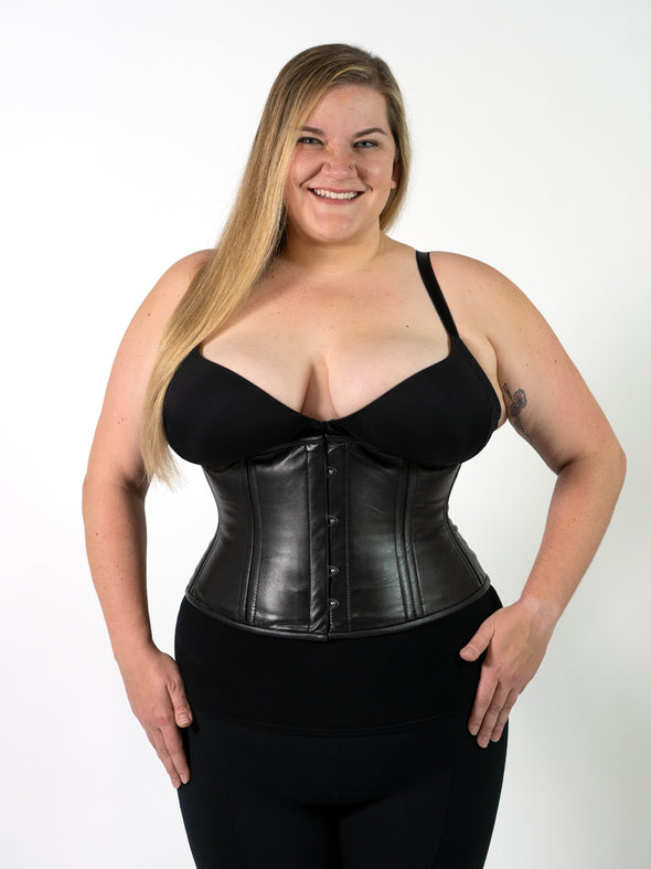 plus size corset model wearing the cs411 black leather waist training corset with a black bra and leggings