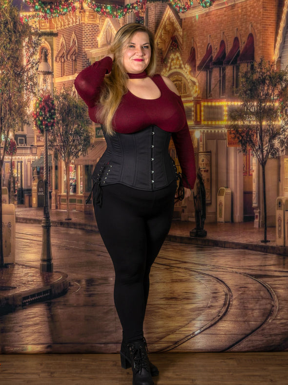 plus size model wearing a 426 black cotton longline waist training corset in a festive scene