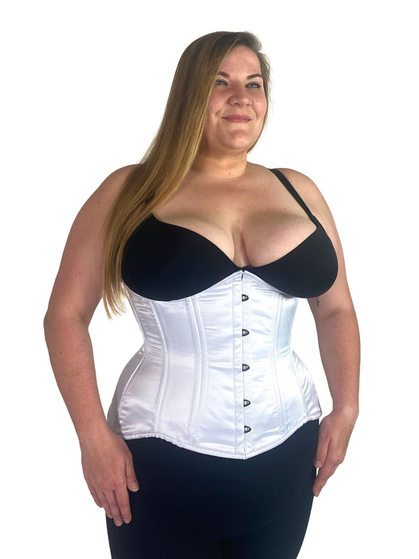 cute curvy corset model wearing a white satin corset over black leggings and black bra great for everyday wear fashion or waist training