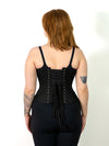 back lace up view of a cute corset model wearing the cs426 hourglass curve waist training black cotton corset with hip ties