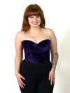 cute smiling model in a plum purple velvet bustier corset top