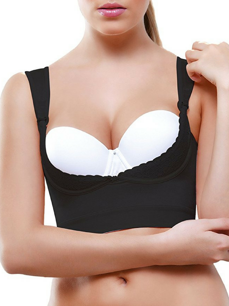 Beautiful realistic female breast in a black bra close-up isolated